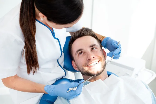 Dentist treating a smiling patient